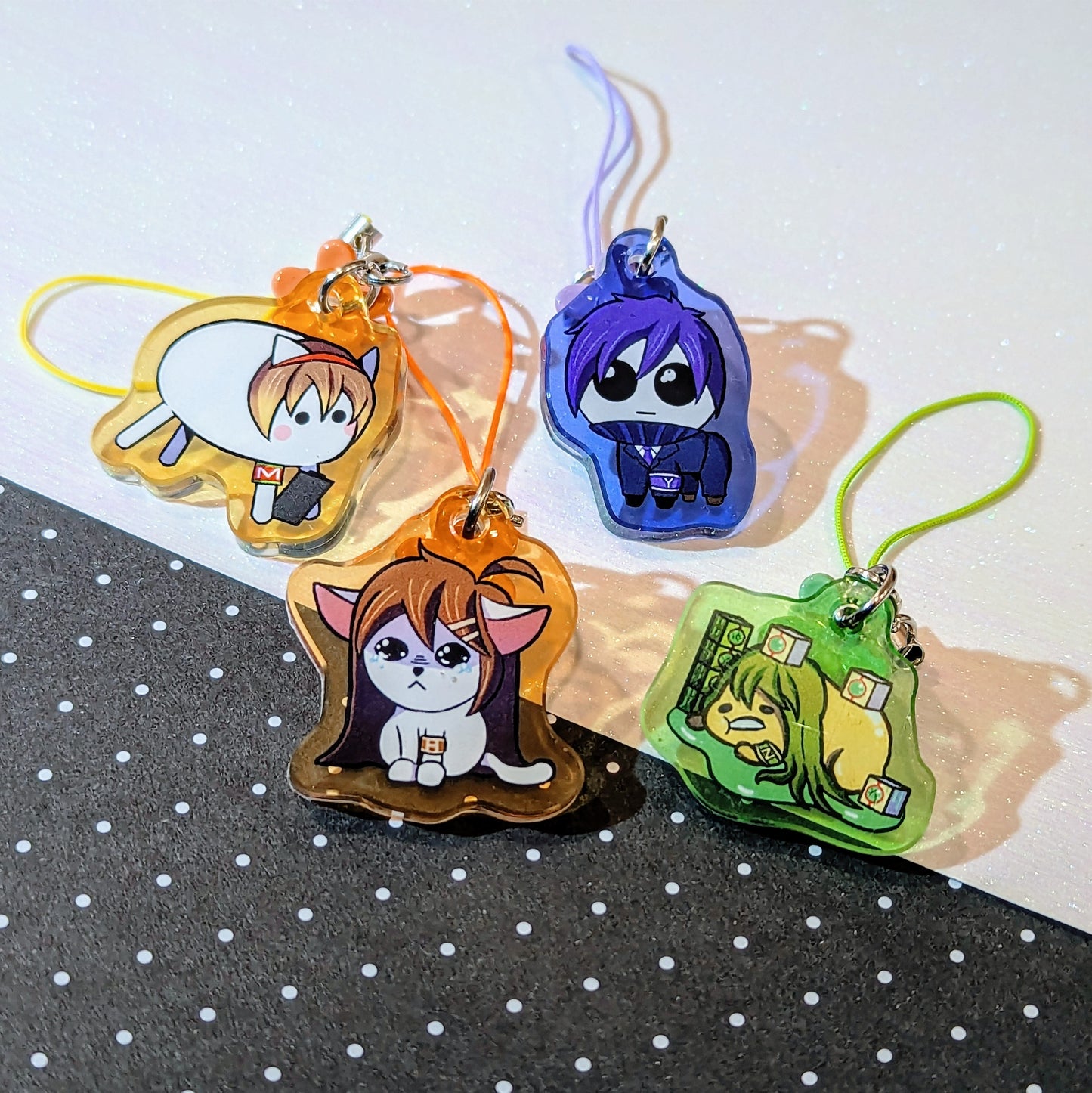 A set of phone charms of Malkuth, Hod, Yesod and Netzach from Lobotomy Corporation. Malkuth is baba from baba is you, Hod is in the meme of a crying cat, Yesod is the autism creature and netzach is the gudetama egg.